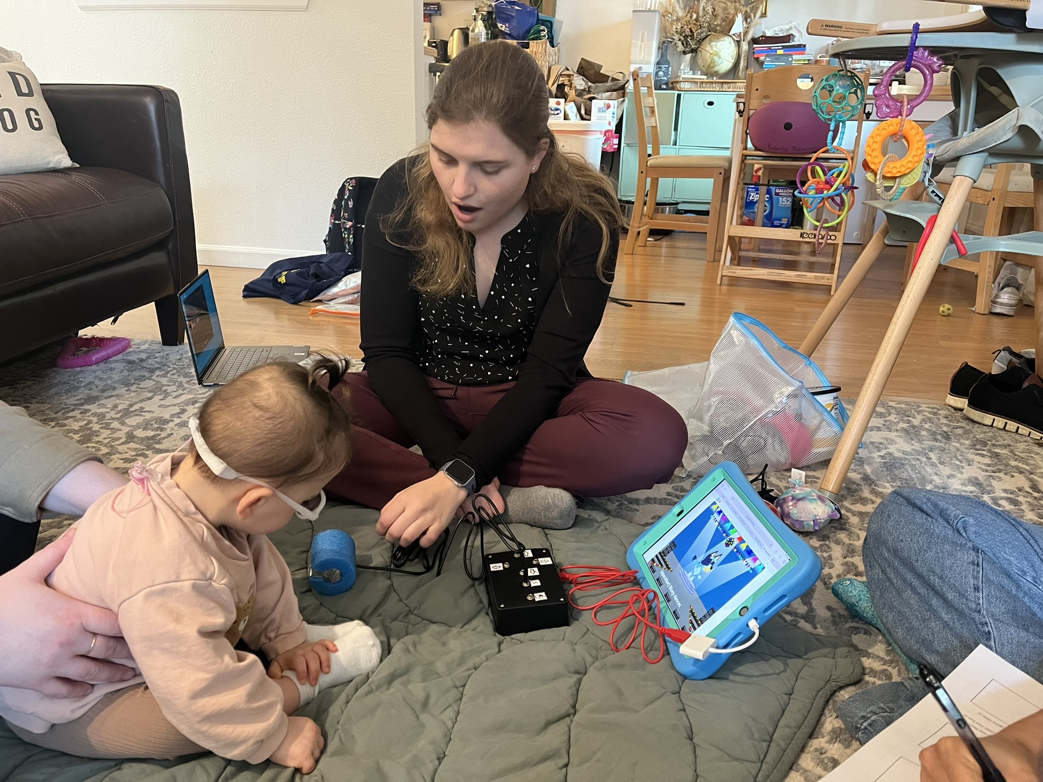 Mia testing out the Switch Kit with a young child wearing glasses.