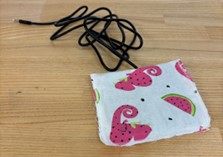 A square piece of fabric with a monoaudiojack coming out of it.